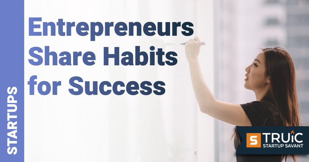 Woman entrepreneur writing her habits for success on a white board.