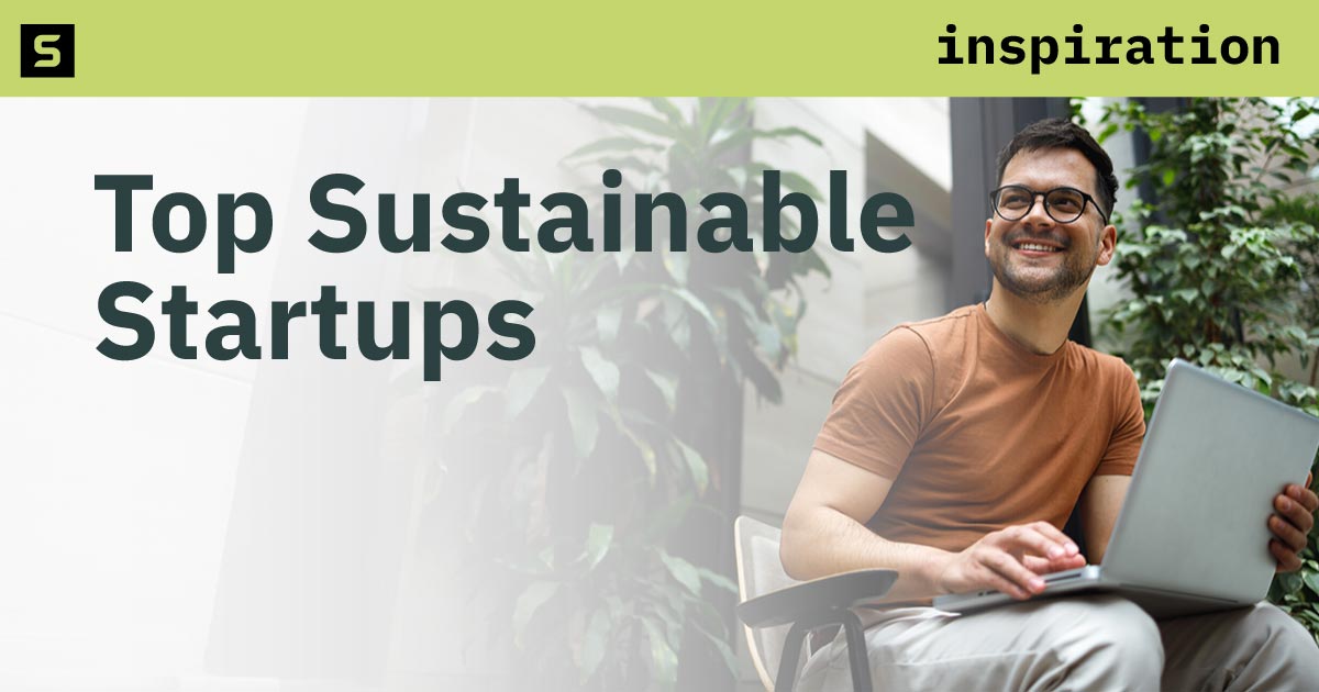 Two women standing in front of a sign that says Innovate.